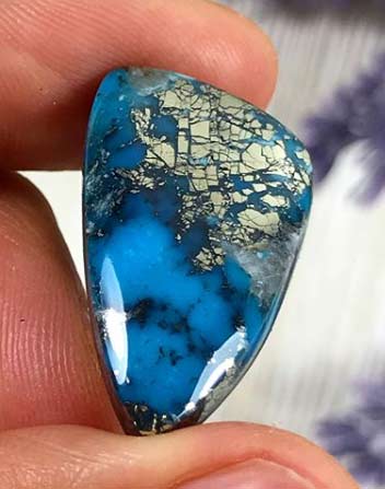 High Grade Ithaca Peak Turquoise cabochon with pyrite