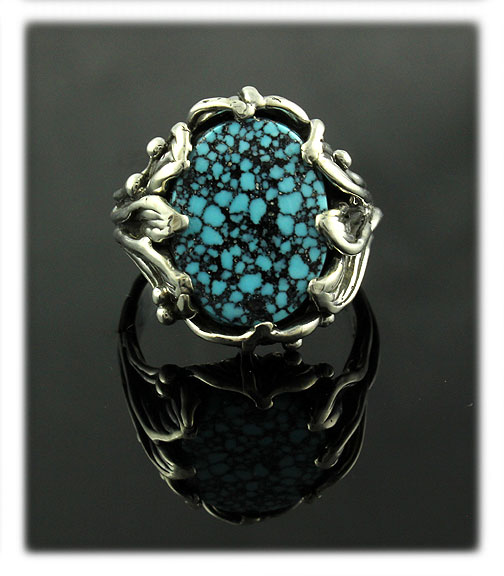 Black Spiderweb Kingman Spiderweb Turquoise Cabochon in a silver ring